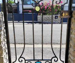 Portillon en fer forgé aux motifs colorés en résine d'Epoxy. Cet ouvrage a été réalisé par La Petite Enclume, entreprise de ferronnerie d'art et de métallerie fine en Côtes d'Armor